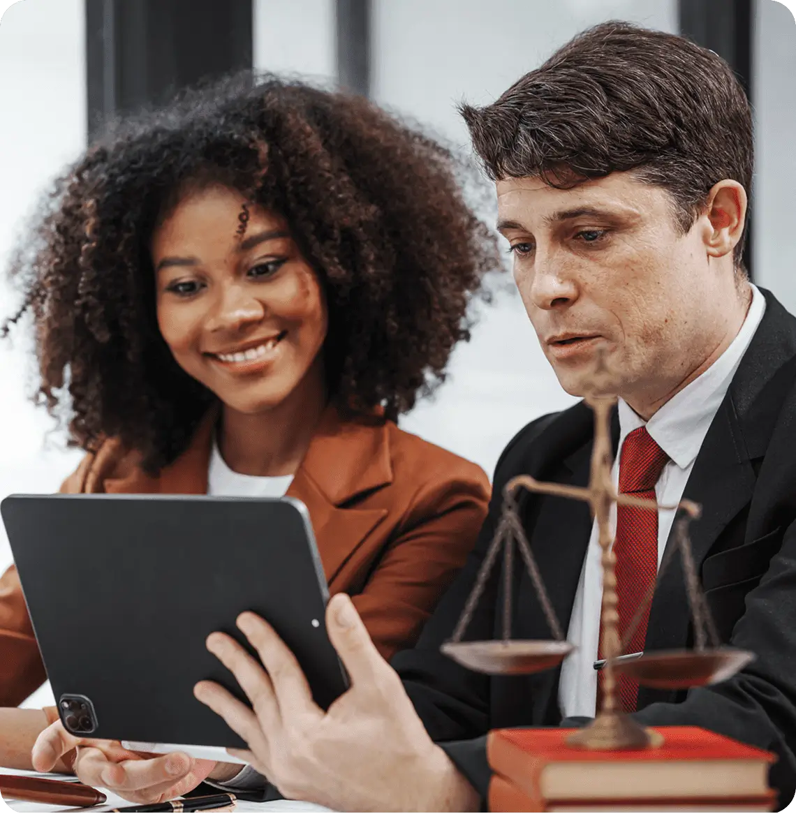 Two professionals discussing over a tablet.